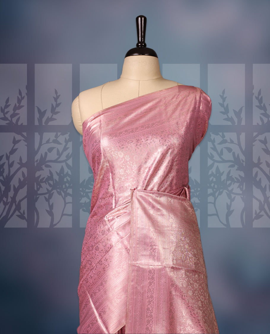 Baby pink colour semi silk brocade saree featuring delicate self design brocade patterns across the body, complemented by a rich self colour woven border and pallu, paired with a matching blouse.