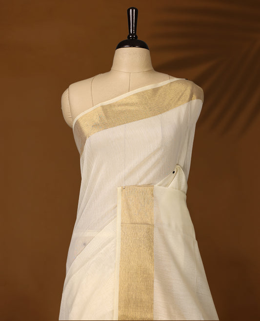 Classic off white colour Kerala saree adorned with a shimmering golden zari border and pallu, finished with elegant tassels. Perfect for festive or traditional occasions, and comes with a matching blouse piece.