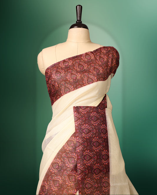 Off White colour kota net saree adorned with Plain body, enhanced by a deep maroon Printed border for bold contrast, and paired with a matching blouse