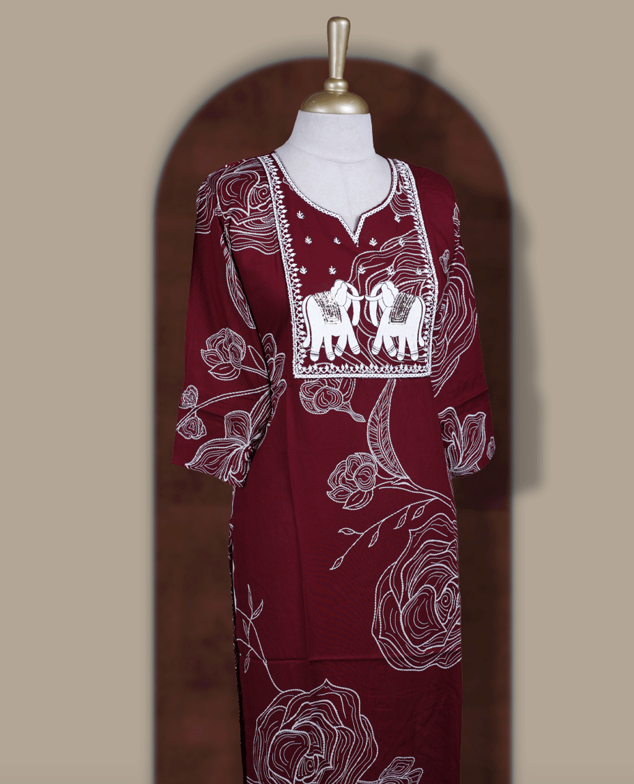 Maroon colour kurti featuring a square embroidered neck design with elephant motif patchwork, V-cut neckline, 3/4th sleeves, and floral printed body.