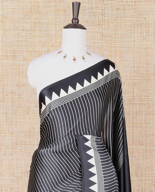Black semi modal crepe saree featuring white vertical line prints, accented with a temple border and Bold circle Motif design on the pallu, paired with a matching printed blouse