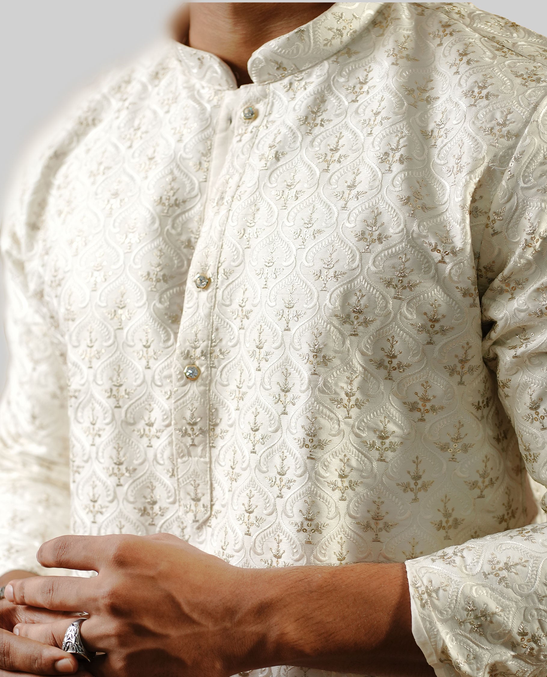 Off white colour men's kurta featuring elegant thread gold zari embroidery work on the body, complemented by full sleeves for a refined and festive look.