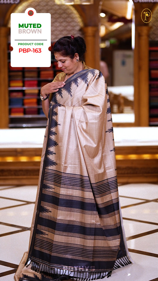 Muted brown colour saree with a sleek dark olive green zigzag pallu, subtle checked body, and striped border & Pair with a matching blouse.