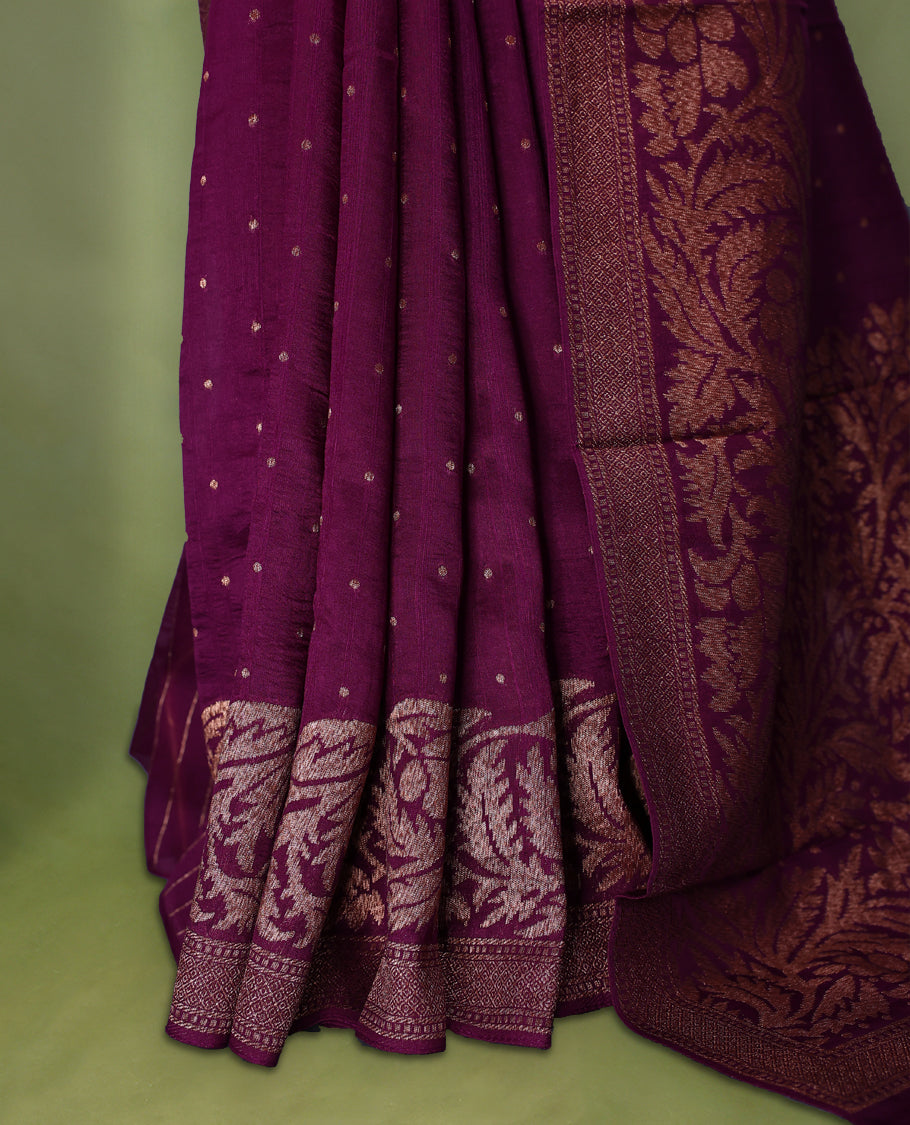 Grape wine colour Tussar Banaras saree adorned with delicate golden zari motifs on the body, rich floral woven zari border and grand pallu, paired with a matching blouse for an elegant and regal traditional look.
