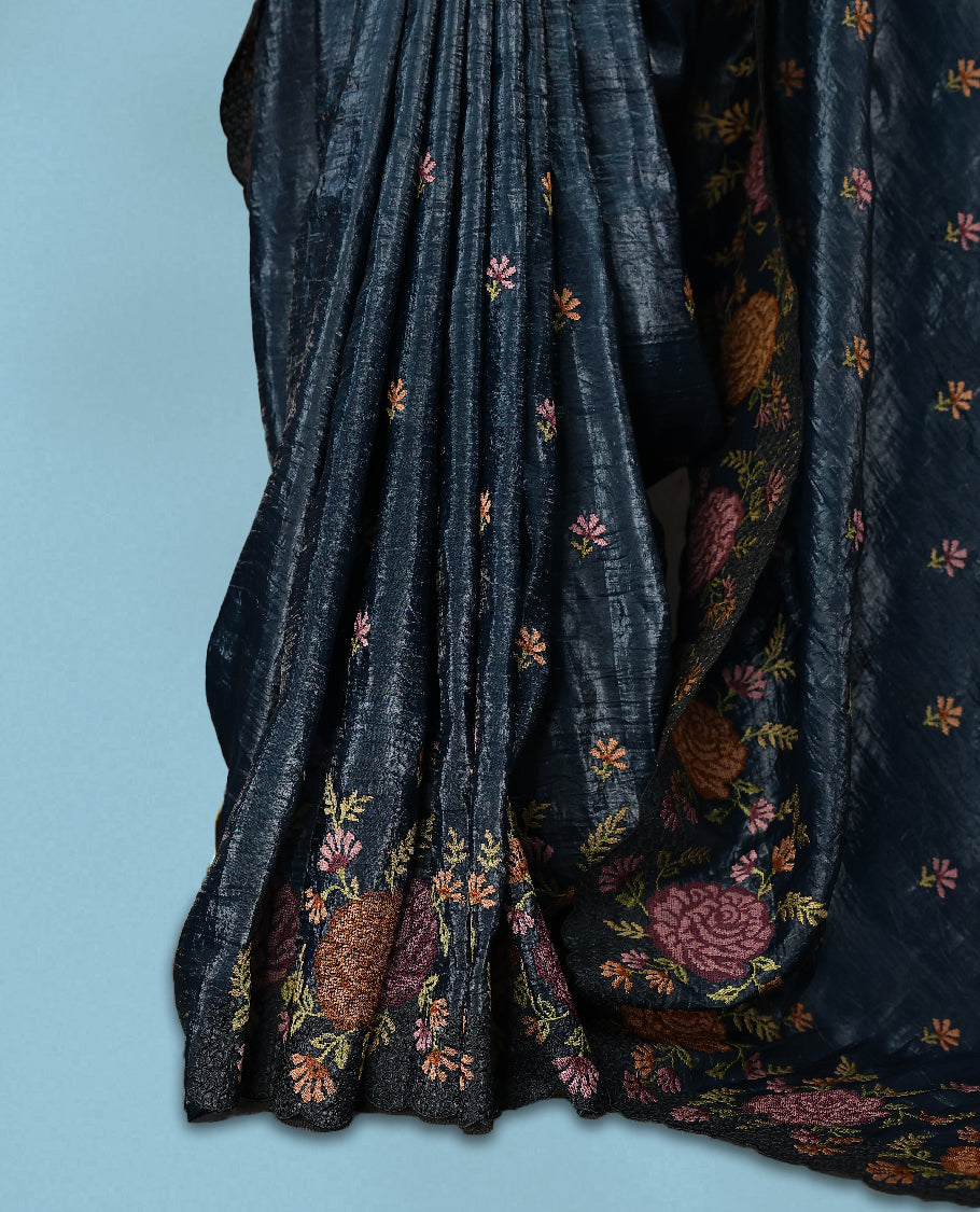 Midnight Blue Colour crush soft silk saree, textured body with a natural crinkled finish, adorned with intricate Multi colored floral Motifs and complemented by a delicate Multi Colour Bold Floral embroidery border, paired with a matching blouse