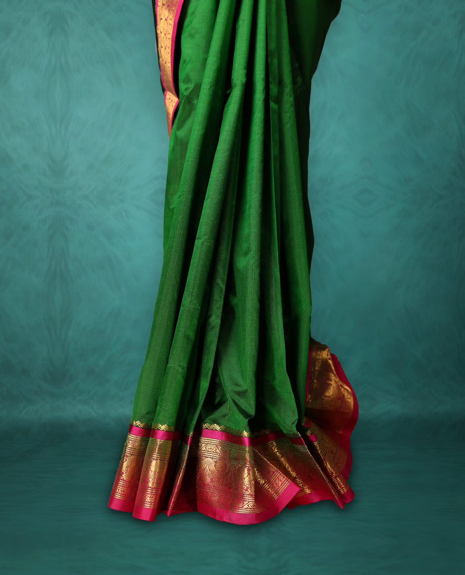 Deep Green colour Dharmavaram saree with small gold motifs on body, Magenta traditional border with intricate gold zari weaving, grand zari pallu, perfect for Bharatanatyam, with matching blouse.