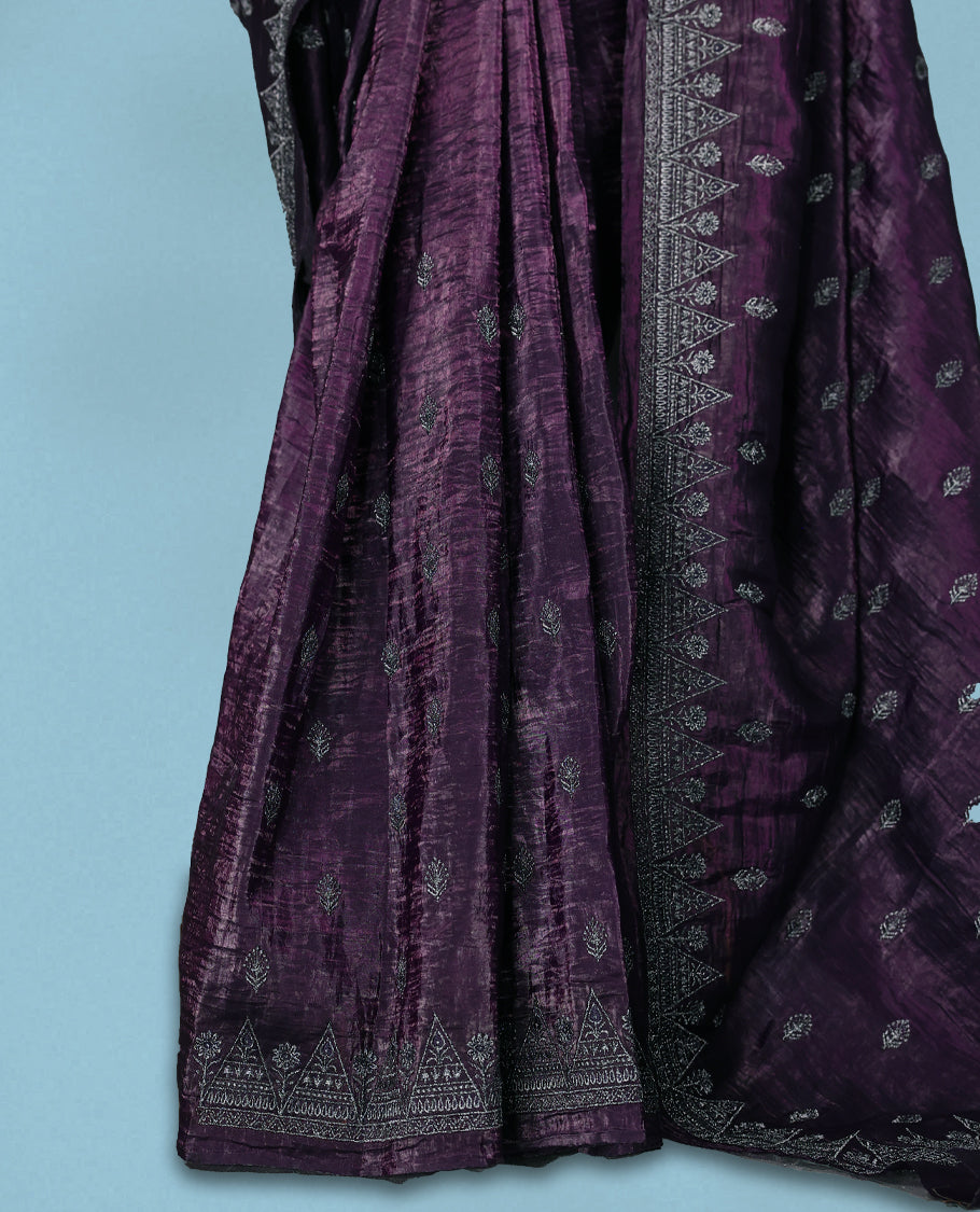 Deep Grape Colour crush soft silk saree, textured body with a natural crinkled finish, adorned with intricate Silver colored Flower like Motifs and complemented by a delicate Silver Zari embroidery border, paired with a matching blouse