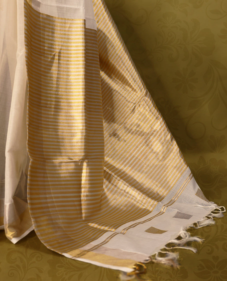 Off white colour pure handloom cotton kerala saree with gold and silver square motifs on the body,  gold and silver zari border, pallu adorned with  gold and silver zari squares motifs, with matching blouse