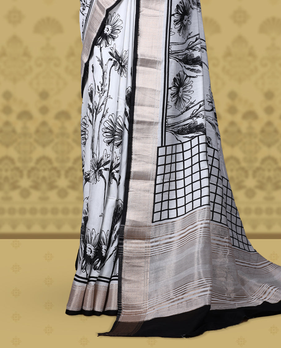 White colour saree with black floral and geometric prints, featuring a contrast zari border and beautifully detailed printed pallu & Comes with a matching blouse piece.