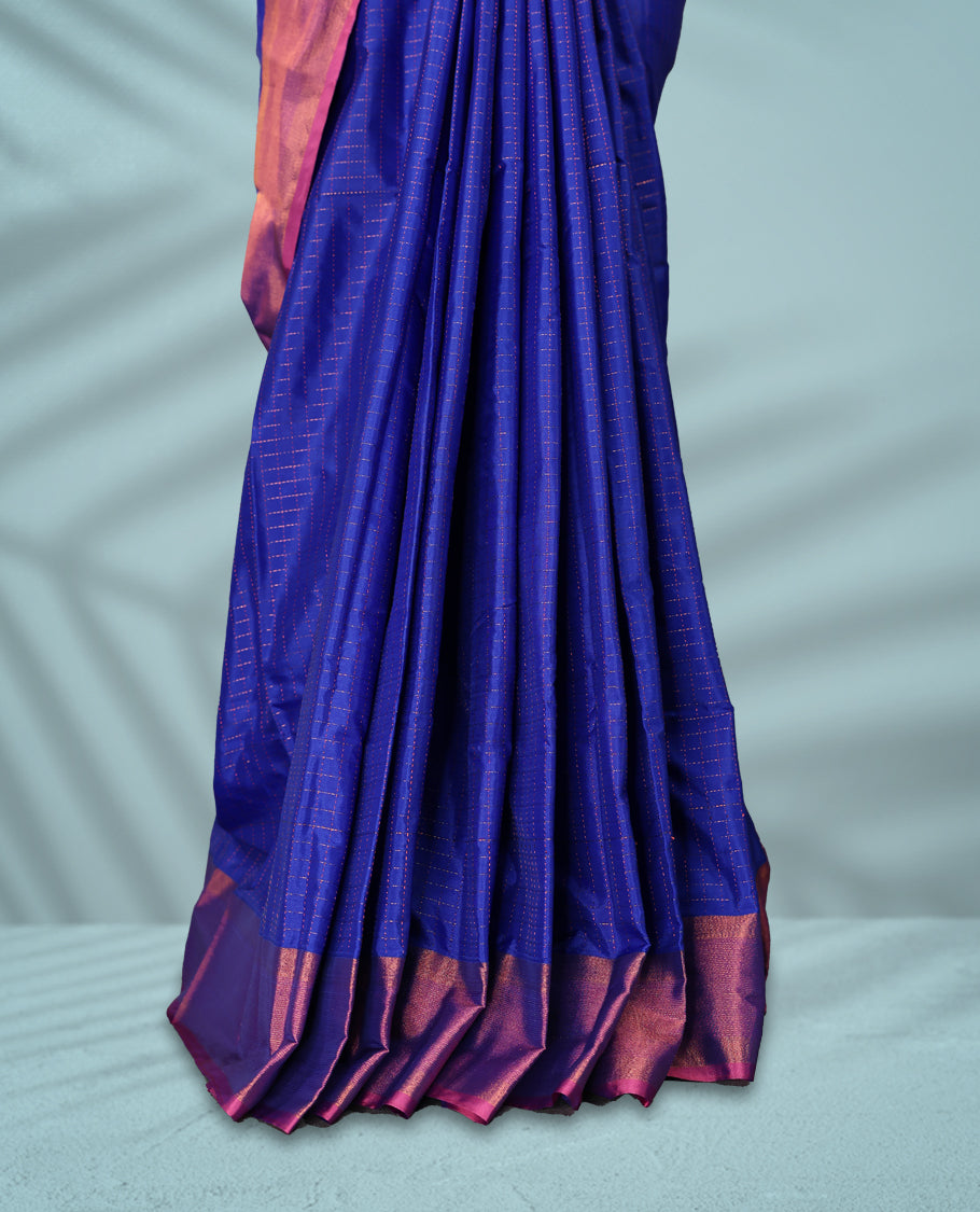Royal blue Colour body with elegant checks, paired with a vibrant magenta pink zari border, comes with a matching blouse.