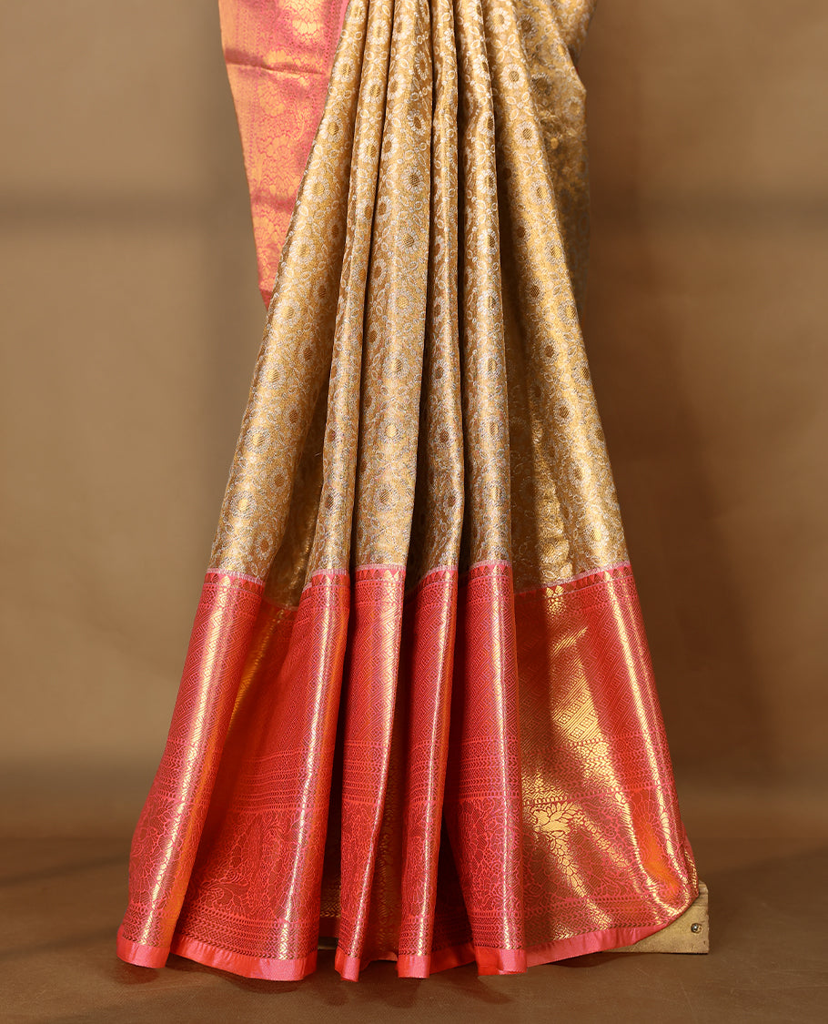 Gold colour tissue brocade saree with gold and silver zari floral & Geometric pattern on body, gold zari traditional floral and peacock work Peach border, rich matching pallu with Antique zari motifs, paired with matching blouse.