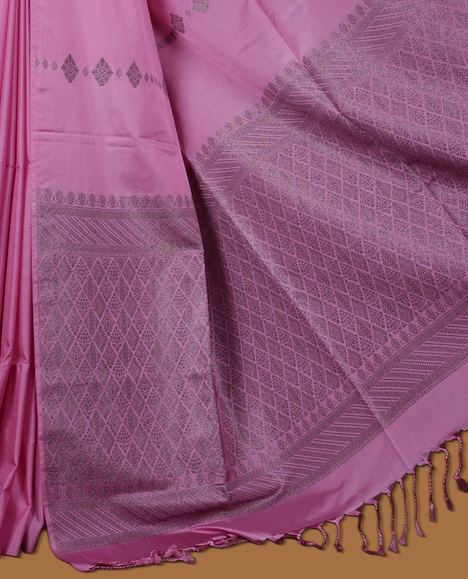 Pink colour semi soft silk saree adorned with delicate woven Diamond motifs on the body, complemented by a Self colour woven pallu with intricate detailing and tassel accents without border & Comes with a matching blouse piece.