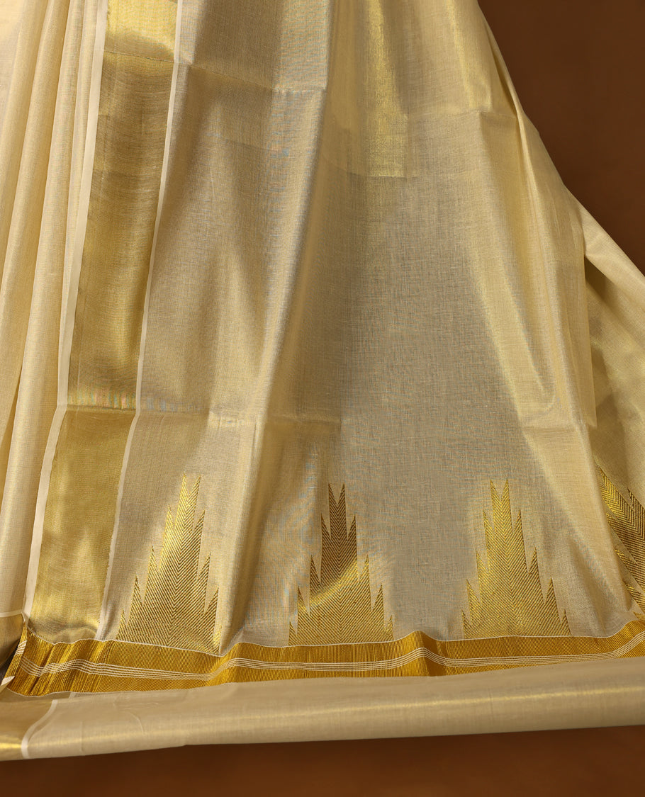 Elegant off white Kerala saree in tissue, featuring a plain body, shimmering gold zari kasavu border, and rich pallu with intricate zari patterns. Comes with a matching blouse, perfect for festive occasions.