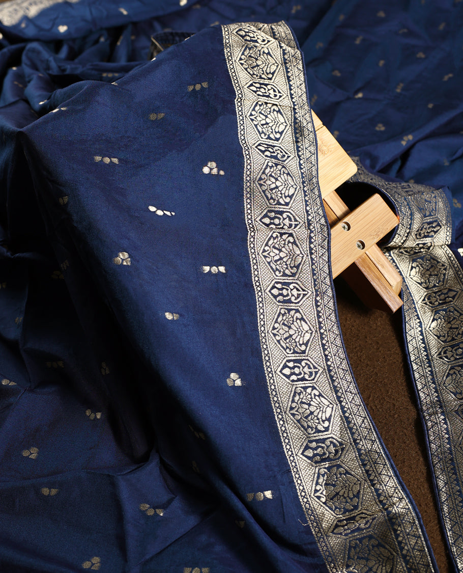 Regal navy blue churidhar material embellished with golden zari floral motifs and an ornate woven border, paired with a plain matching bottom and grand dupatta, perfect for weddings, festive occasions, and royal celebrations.