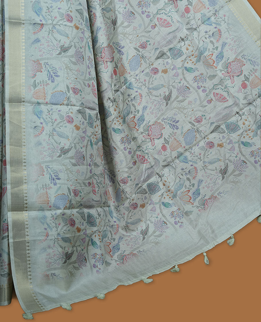 Powder blue colour semi tussar silk saree featuring all over floral and leaf motifs on the body with a subtle self border and tasselled pallu, paired with a matching blouse.