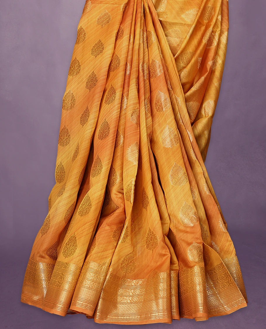 Mustard colour pure Banarasi Chanderi cotton, beautifully enhanced with hand-brushed colour and traditional antique zari butta motifs across the body, paired with traditional border and a matching blouse.
