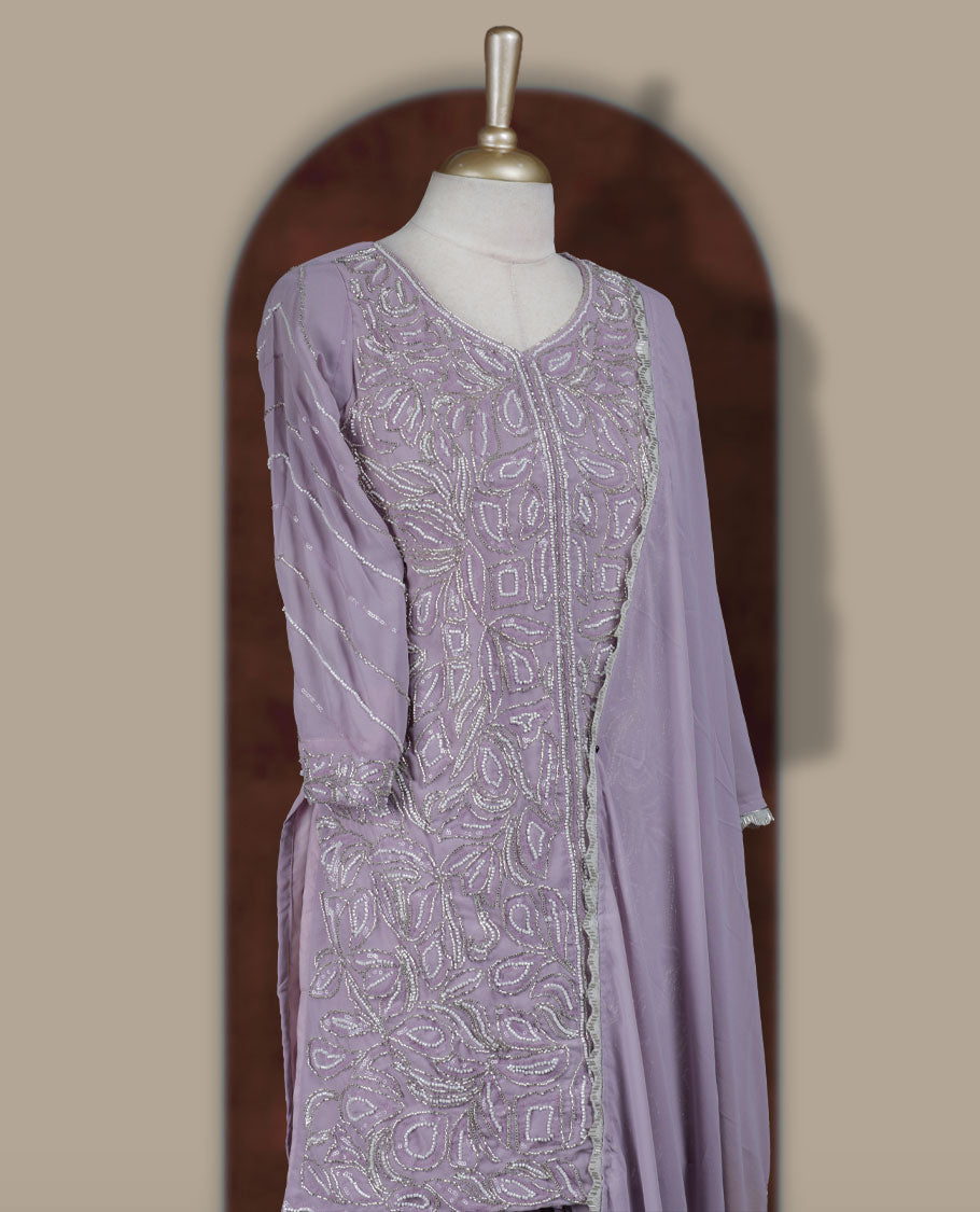 Elegant Lavender colour sharara set featuring an intricately embroidered top with cut beads work and three quarter sleeves, paired with a flowy flared bottom and a matching dupatta adorned with delicate borders.
