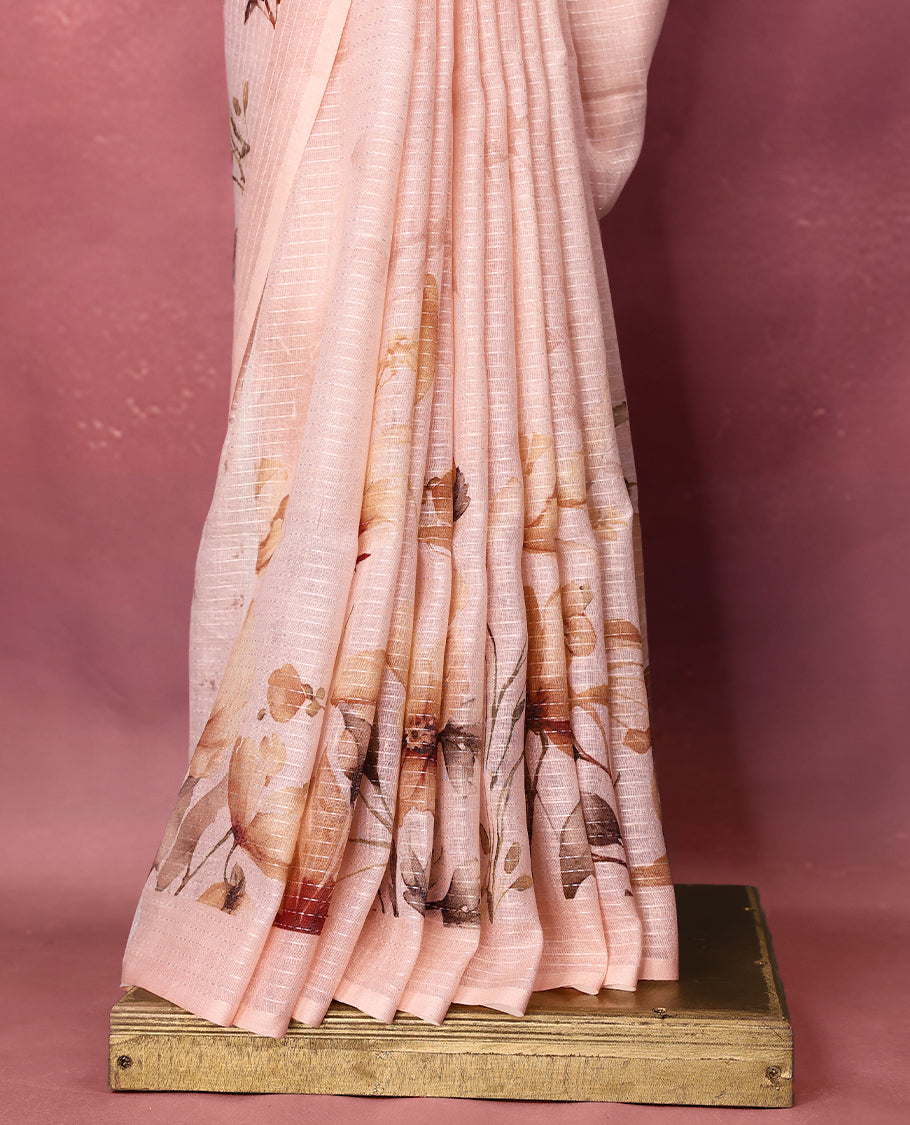 Light Pastel Peach colour pure linen saree featuring elegant floral prints in earthy tones all over the body, finished with a minimal border and comes with a matching blouse