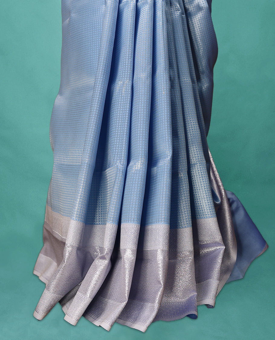 Light Blue coloured semi silk saree featuring a Check design on the body, paired with a Baby Blue coloured border and matching blouse.