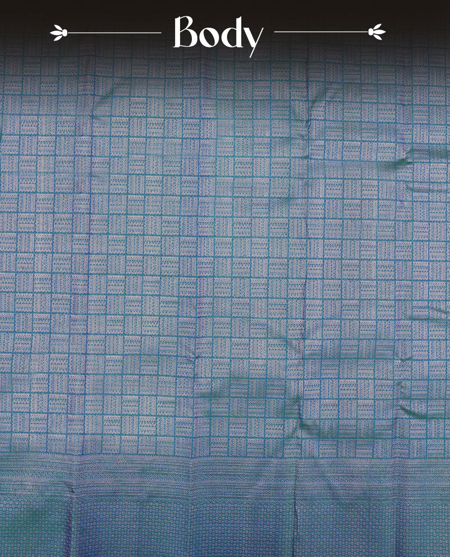 Peacock blue colour Kanchipuram pattern Manthrakodi saree featuring intricate geometric antique copper zari brocade design across the body, beautifully complemented with a matching self brocade blouse piece.