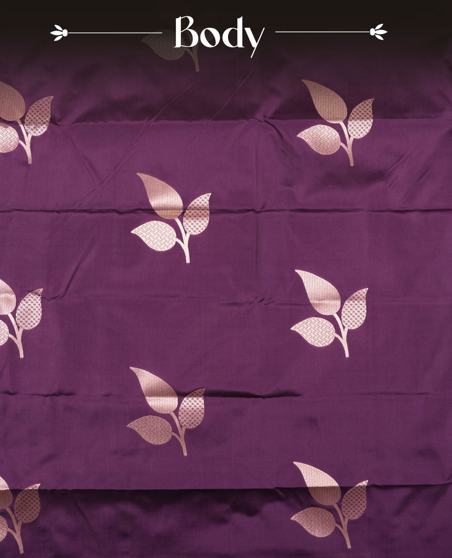 Dark purple colour semi silk saree adorned with elegant leaf motifs on the body, complemented by a shimmering golden zari-woven pallu and border, and paired with a matching blouse