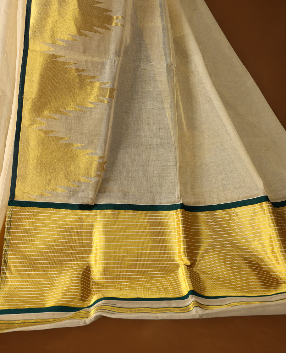 Elegant off white colour pure handloom soft tissue saree with golden zari detailing and green edging, Sheer, lightweight, and lustrous & paired with a matching blouse, perfect for weddings and festive occasions.