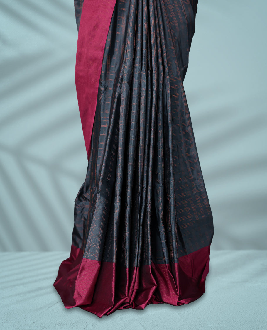 Deep Grey Colour semi silk saree features a fine checked body design, complemented by a rich Wine border, and comes with a matching blouse.