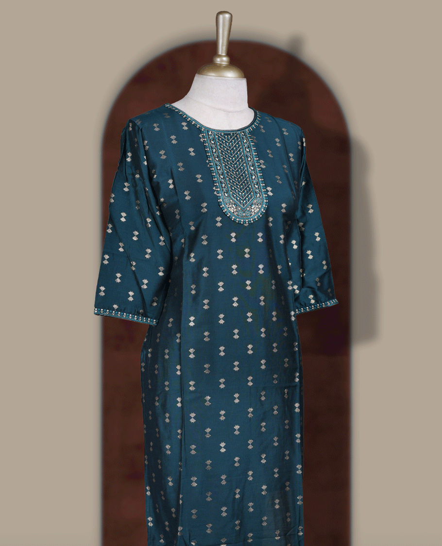 Dark peacock green colour kurti from TWARA, featuring intricate golden foil prints all over and elegant embroidery on the neckline, finished with a round neck and elbow length sleeves.