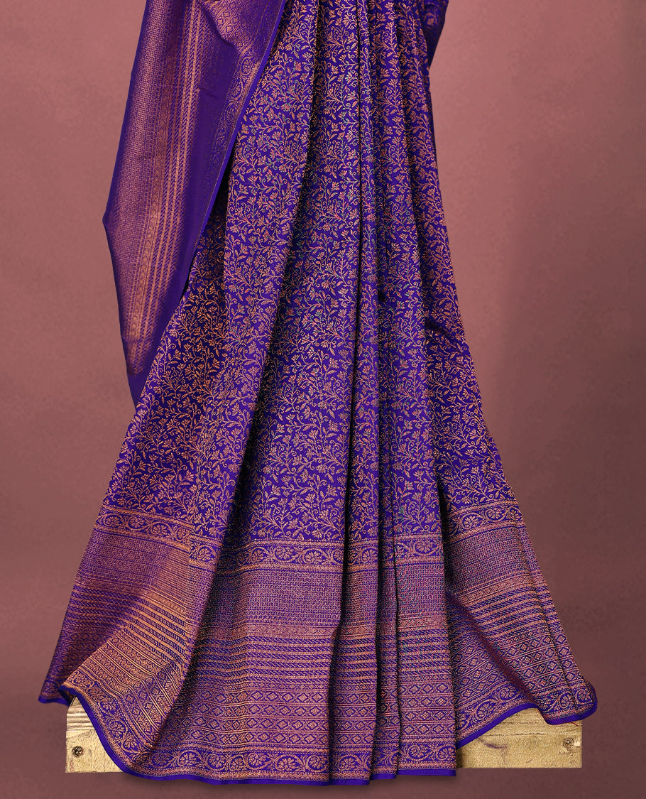 Deep Violet colour Kancheepuram saree featuring an antique zari brocade body, complemented by a traditional border and a matching blouse.