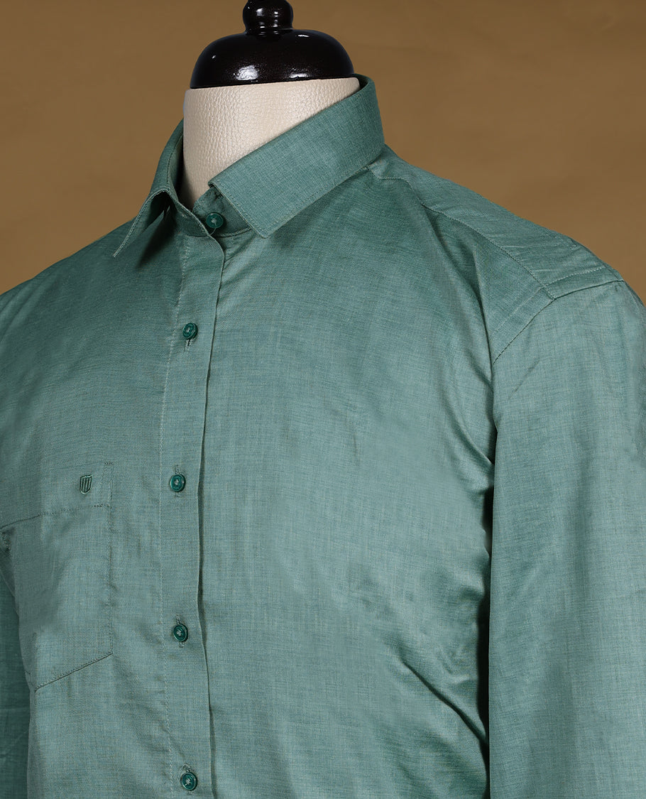 Dusty teal green colour OTTO men’s shirt in a relaxed formal fit featuring a subtle self textured body, classic collar, full sleeves, and front chest pocket ideal for office or smart casual wear.