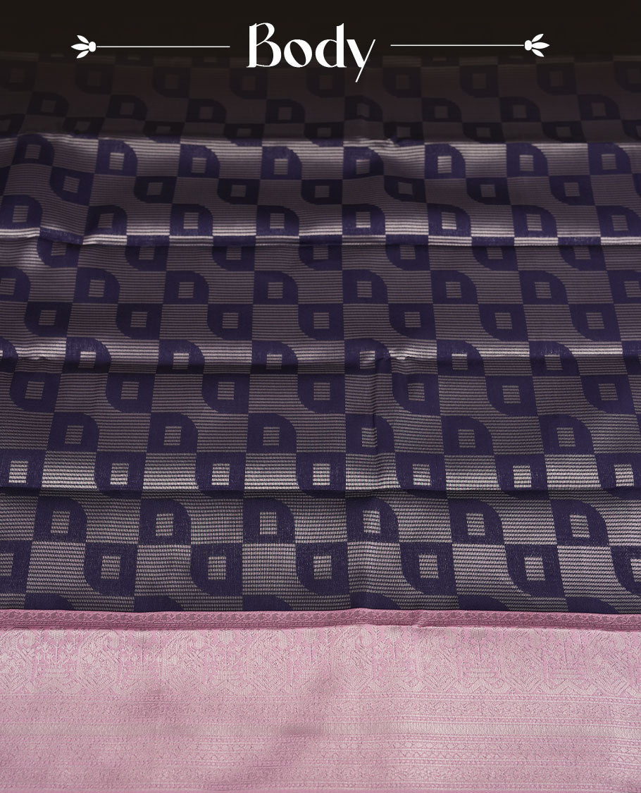 Navy blue colour semi silk saree adorned with silver zari motifs on the body, complemented by a pastel pink pallu intricately woven with rich floral patterns border and pallu, and paired with a matching blouse