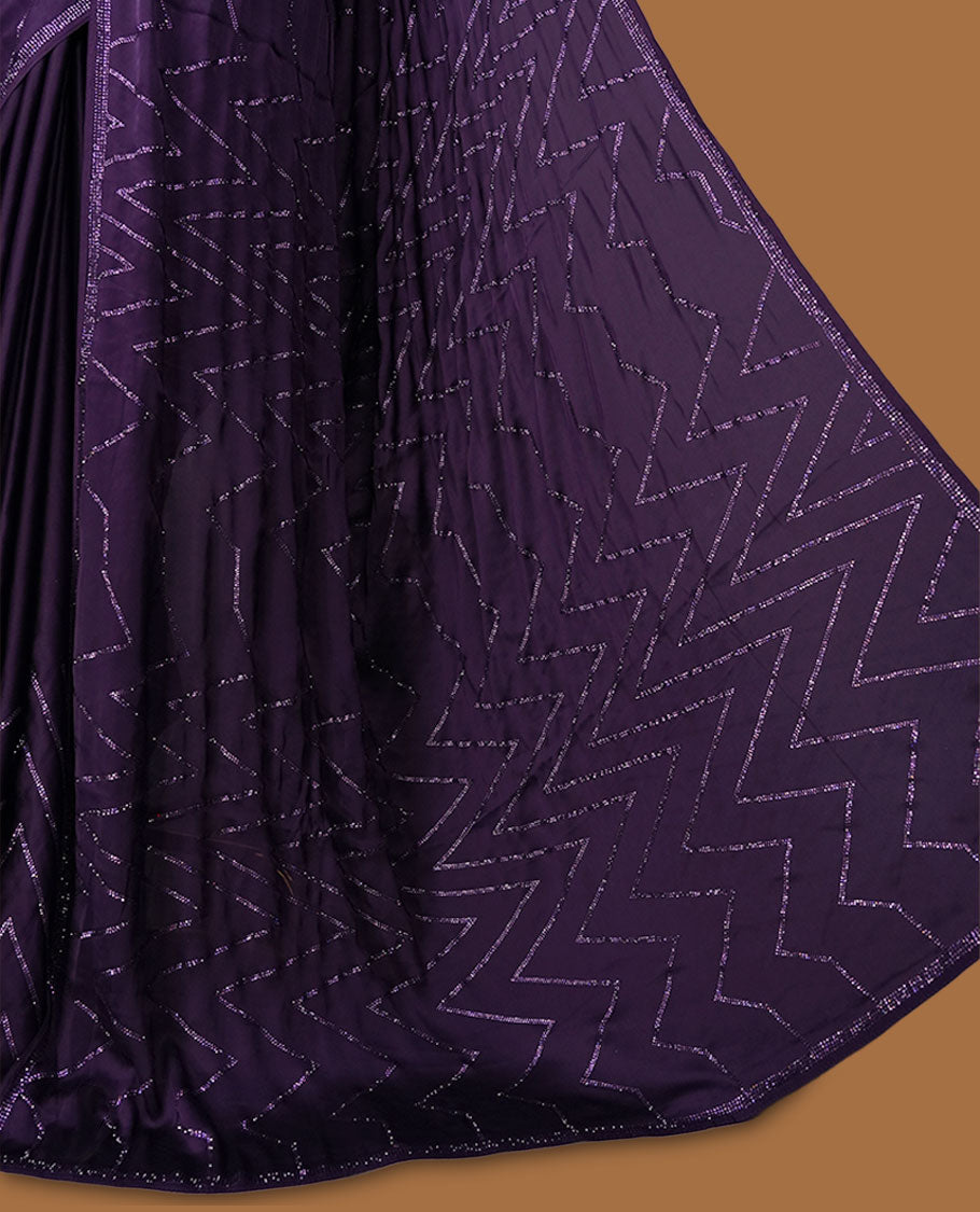 Dark violet Colour shimmer fancy saree adorned with red stone buttas all over the body, paired with a delicate stone worked border and matching blouse featuring floral vine stone embroidery