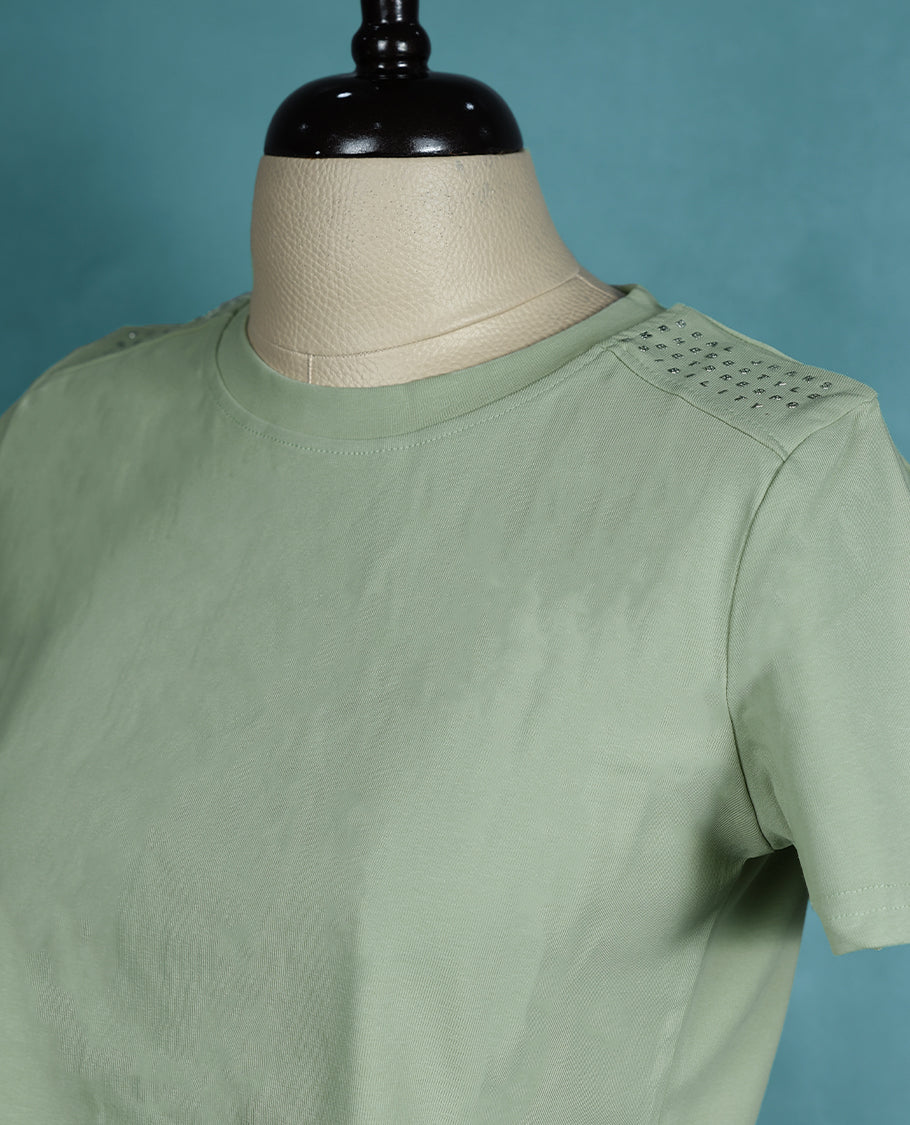 Pastel Green short sleeve T shirt with a round neck, featuring subtle stud detailing on the shoulders for a sleek, edgy twist on everyday comfort.