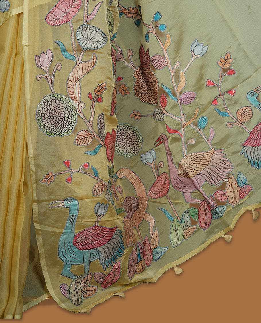 Pastel yellow colour organza saree with multicolour thread embroidery on the pallu and fine border detailing, paired with a matching blouse.