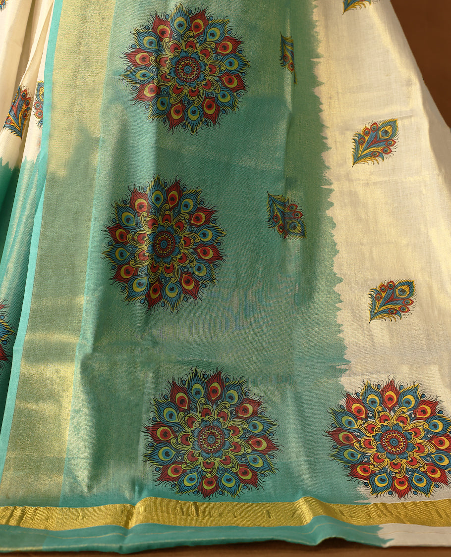 Pastel Green & Light Gold colour Tissue Kerala saree featuring Bold Floral Printed body and traditional golden zari kasavu border offering a classic and graceful look, paired with a matching blouse.