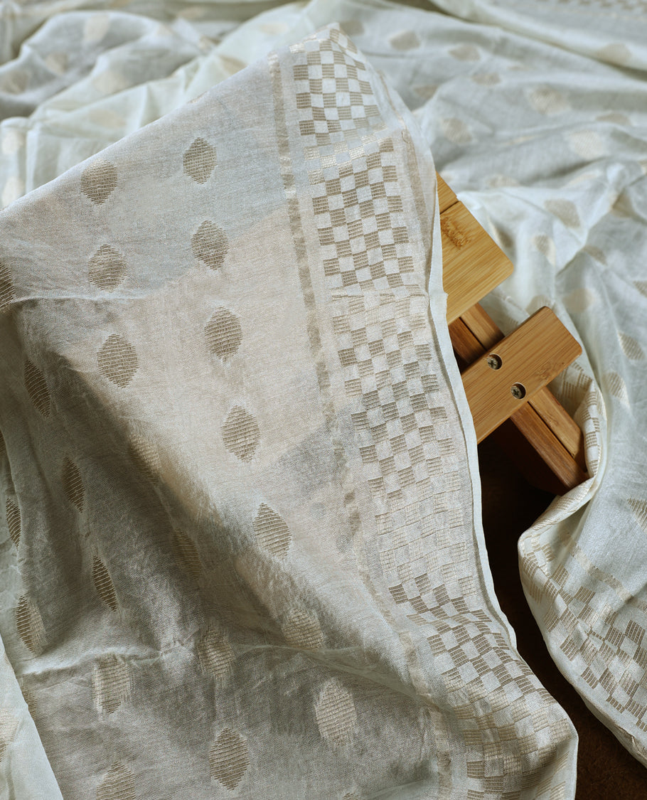 Elegant off white colour churidhar material featuring intricate woven patterns and subtle paisley embroidery, paired with a plain matching bottom and a delicately designed dupatta, perfect for timeless festive and traditional wear.