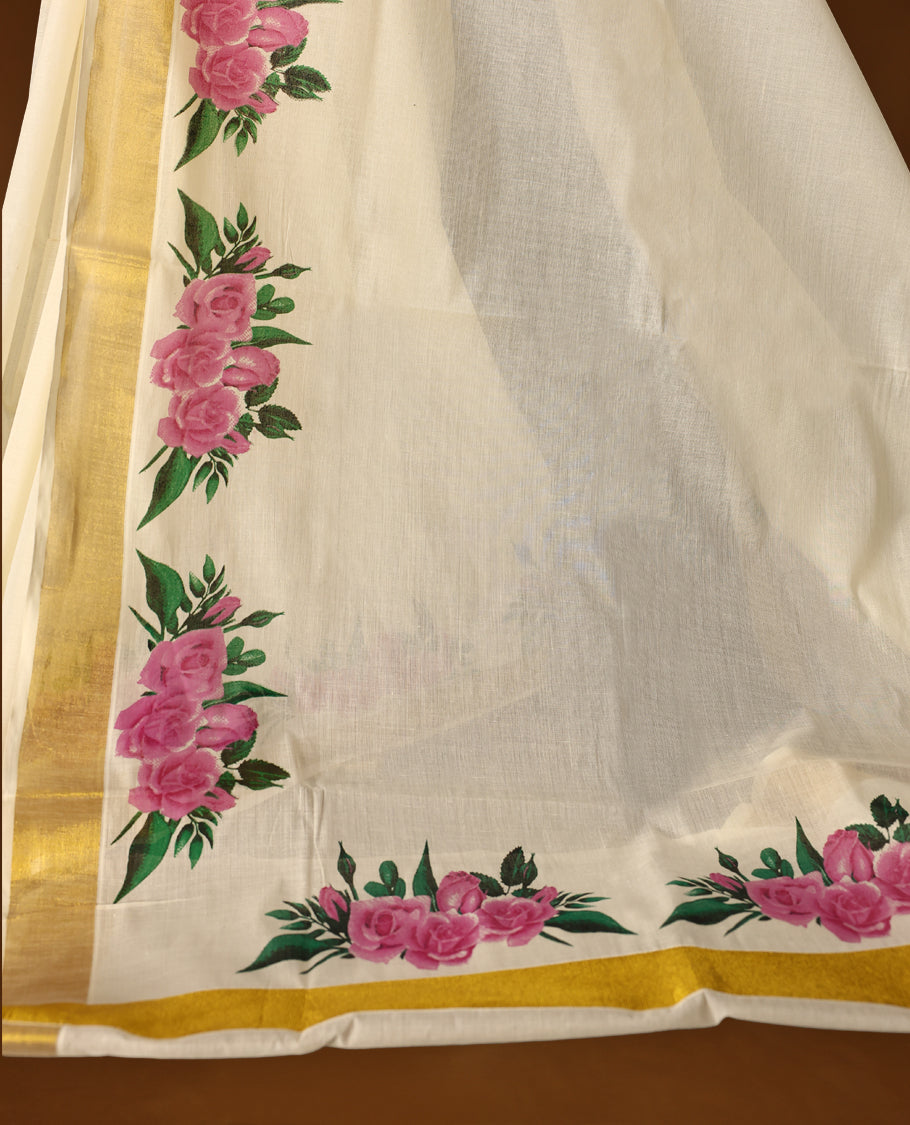Graceful off white colour Kerala cotton saree with bold pink floral prints and a golden zari border, Lightweight and elegant, it comes with a matching blouse & perfect for festive and semi-formal occasions.