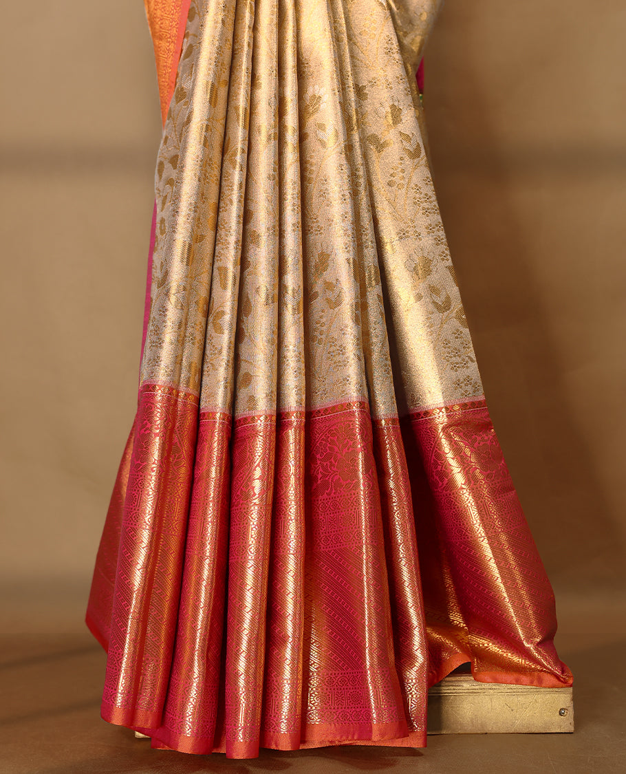Gold colour tissue brocade saree with gold and silver zari floral kodi design on body, gold zari floral and peacock work pinkish orange border, rich matching pallu with Antique zari motifs, paired with matching blouse.