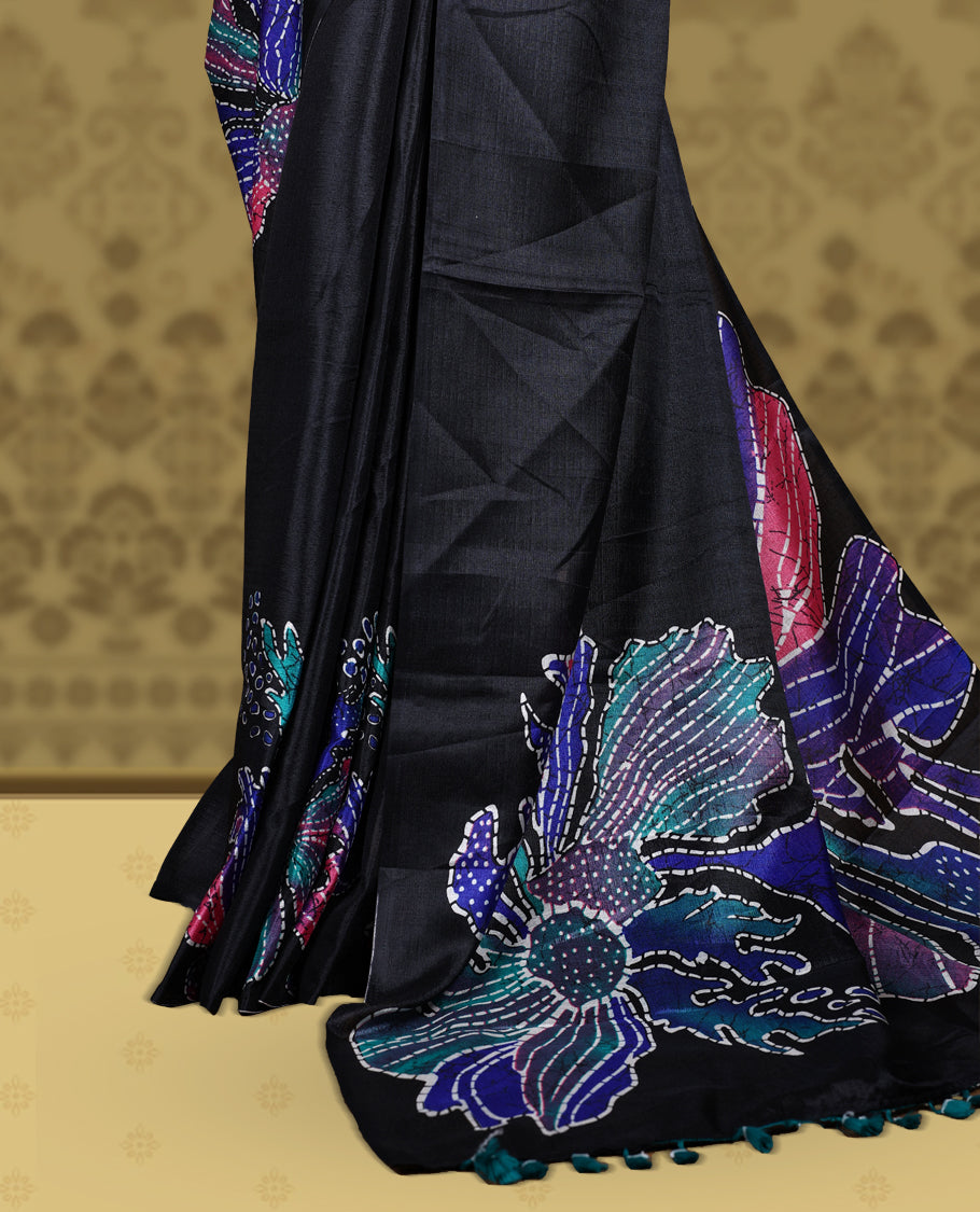 Black colour semi khadi silk saree adorned with navy blue,pink and aqua green colour bold floral motifs across the body, designed without a border for a contemporary touch, and paired with a matching blouse.