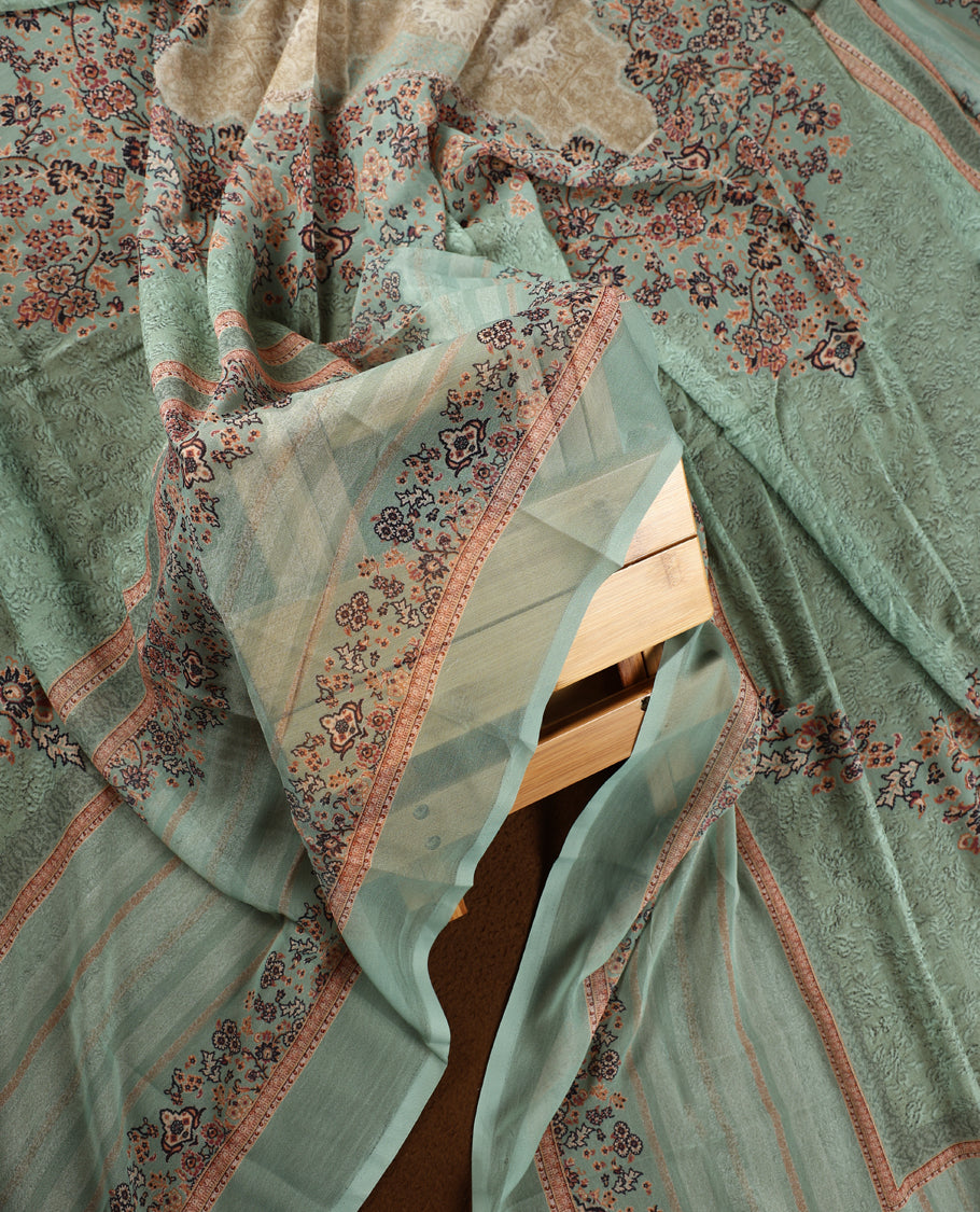 Pista green colour churidhar material with intricate floral prints, sequin embroidery on the top, plain matching bottom, and a coordinated dupatta.