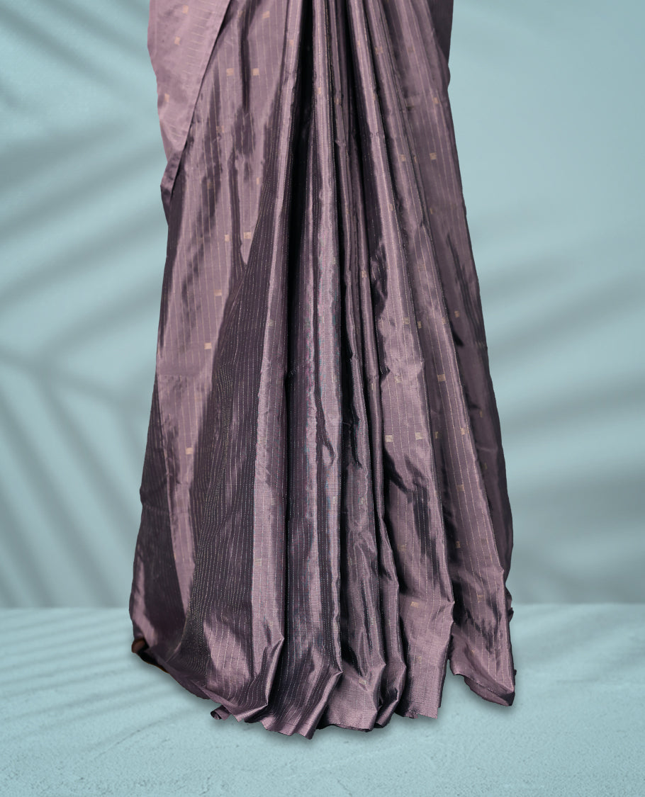 Greyish Purple colour semi silk saree features a subtle checkered pattern woven with delicate threadwork across the body, crafted without a border and paired with a matching blouse