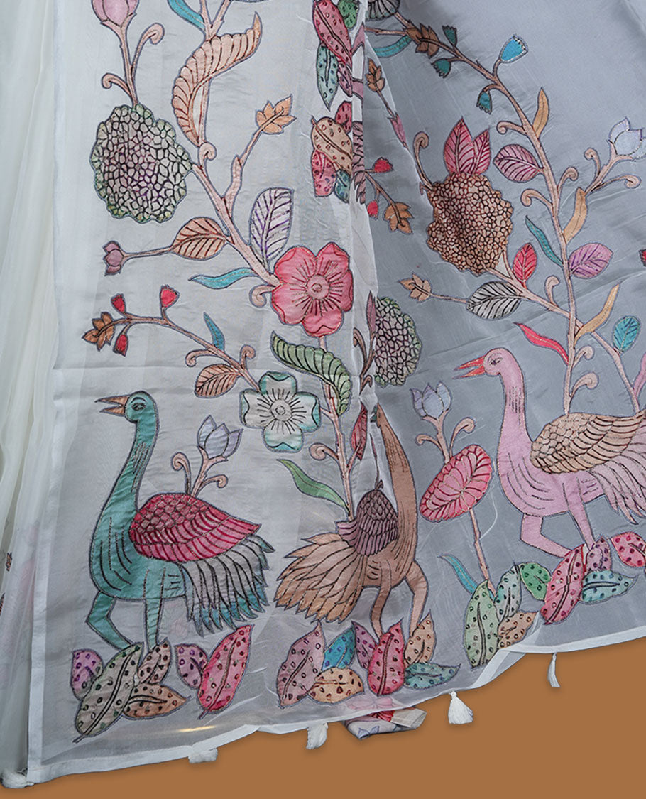 Ivory white colour organza saree featuring multicolour floral and bird printed motifs on the pallu with a subtle fine border, paired with a matching printed blouse.