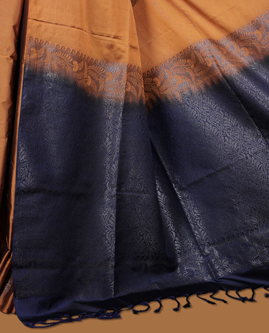 Mustard colour semi soft silk saree adorned with delicate woven floral kodi motifs on the body, complemented by a contrast navy blue colour woven pallu with intricate detailing and tassel accents without border & Comes with a matching blouse piece.