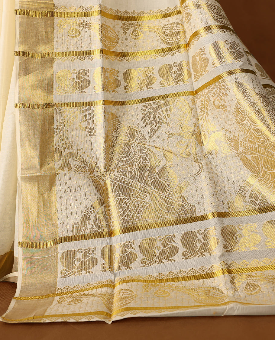 Elegant off white colour cotton Kerala saree featuring Gold zari Floral motifs on body, traditional golden zari kasavu border & Rich Pallu offering a classic and graceful look, paired with a matching blouse.