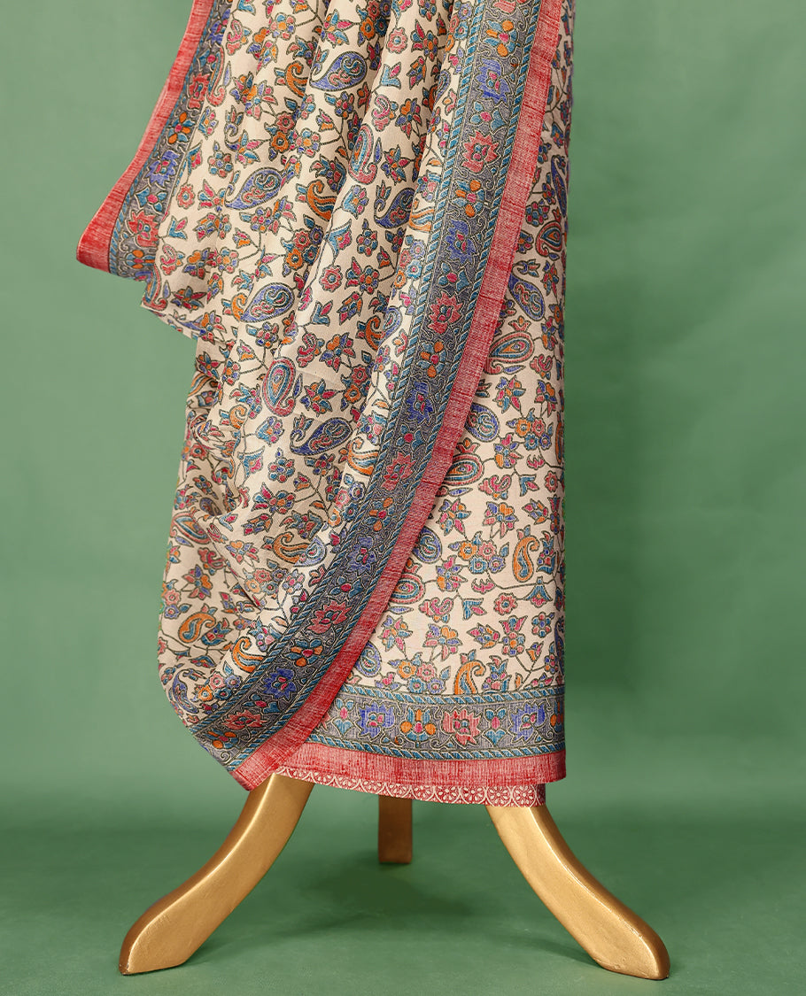 Ivory cream colour Manipuri saree showcases a body adorned with vibrant paisley and floral block motifs, framed by a contrasting blue floral printed border with red piping, and paired with a matching blouse.