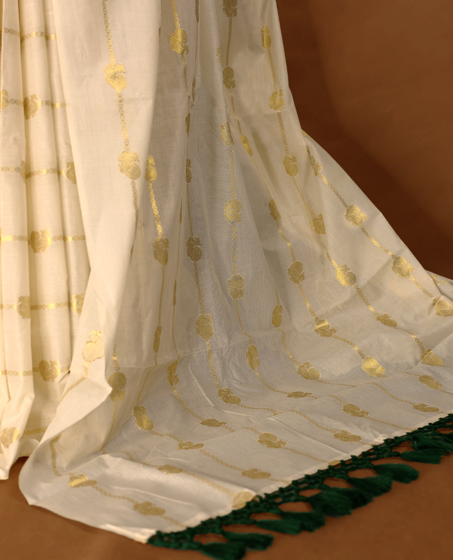 Light Gold colour Cotton Kerala saree featuring gold zari Stripes with peacock motifs on body, without border, paired with a matching blouse perfect for festive occasions.