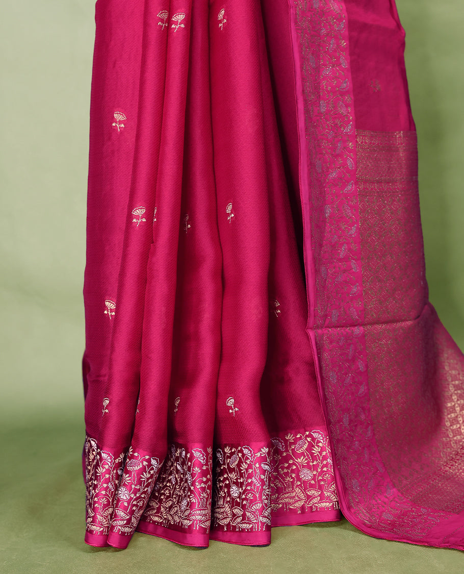 Magenta colour pure Banaras crepe saree showcases elegant Gold zari Flower Motifs all over the body, a traditional gold & Silver zari border, a rich intricately woven pallu, and comes with a matching blouse.