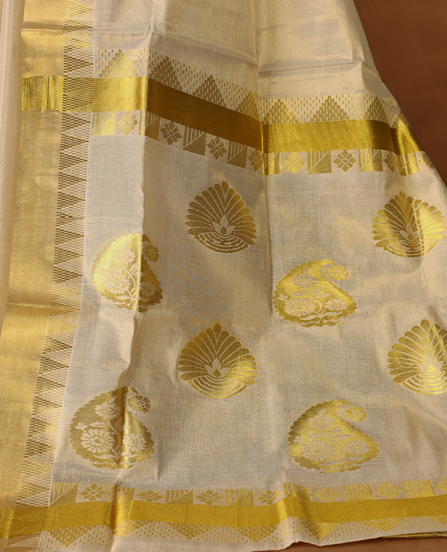 Elegant Light Gold colour Tissue Kerala saree featuring Gold Zari Motifs on body, traditional golden zari kasavu border & Rich Pallu offering a classic and graceful look, paired with a matching blouse.