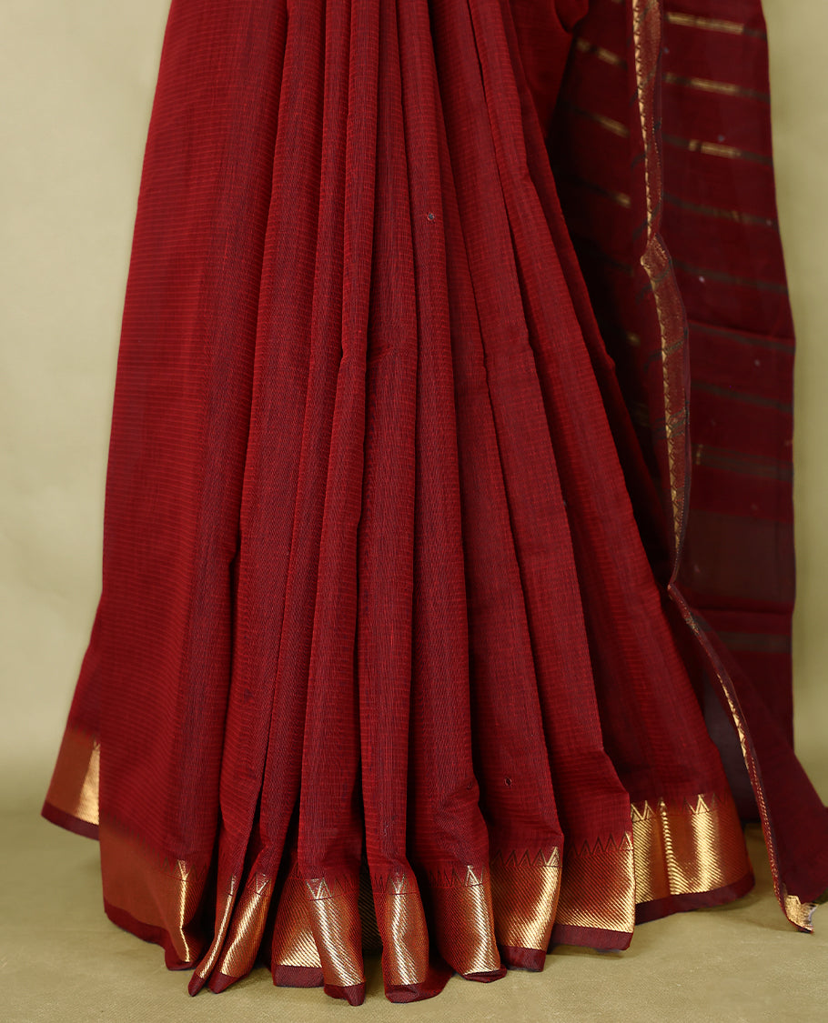 Maroon colour Chanderi cotton saree featuring a subtly textured body with delicate buti work, complemented by a rich golden zari border with matching blouse