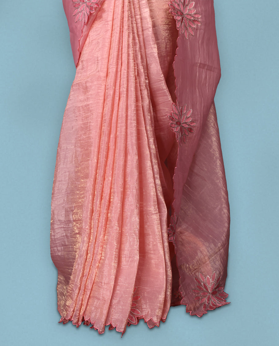Peach colour crush soft silk saree adorned with bold floral thread embroidery on the body and scallop edged borders, Paired with a matching blouse for a complete look.